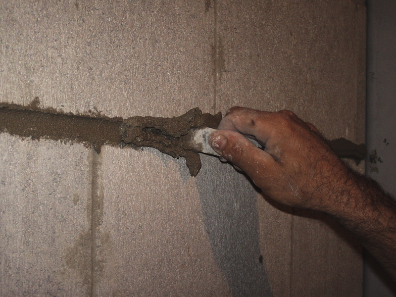 image of tuckpointing a basement wall